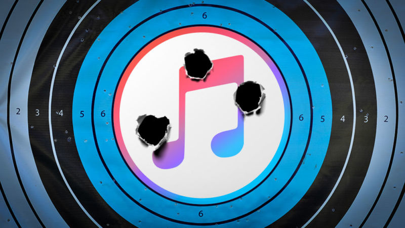 The iTunes logo has been photoshopped onto a pistol target that has been shot multiple times.