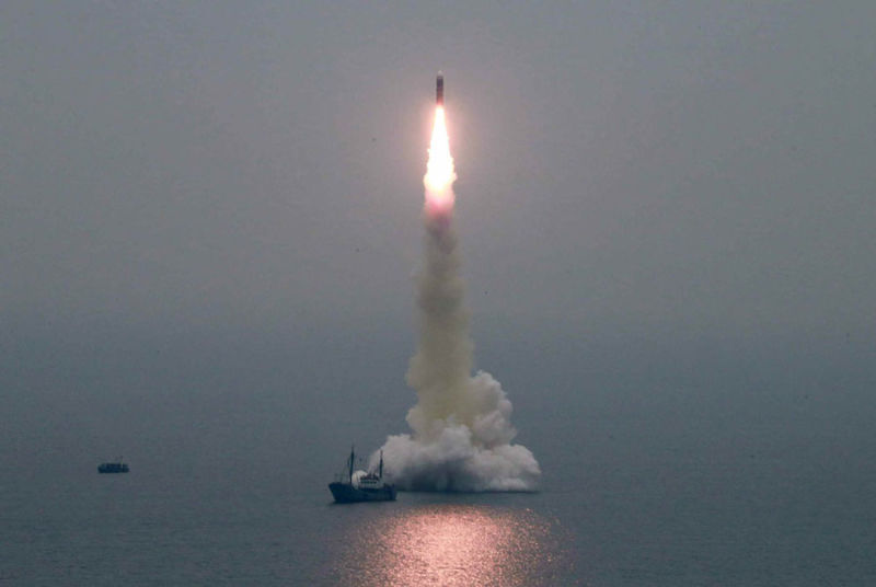 The Pukguksong-3 missile rises after being launched from a towed barge off North Korea's eastern coast.