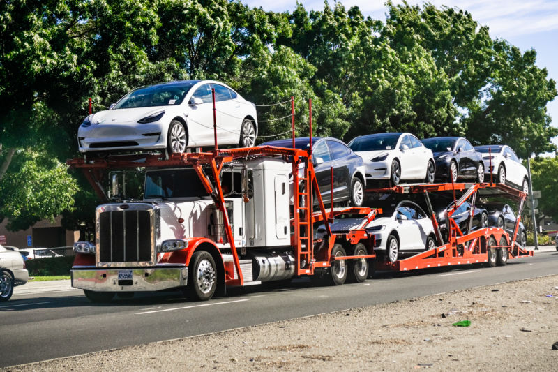 A truck full of Model 3 cars.