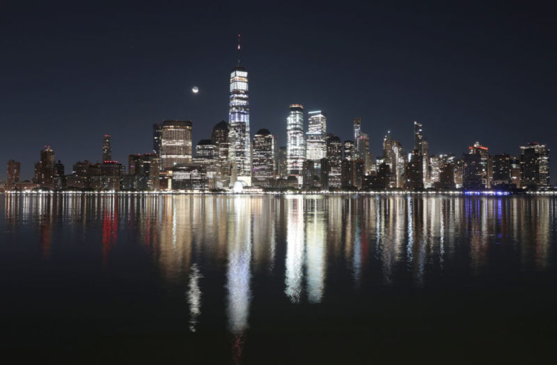 A crescent moon rises in the pre-dawn sky over the skyline of lower Manhattan and One World Trade Center in New York City on October 25, 2019 as seen from Jersey City, New Jersey. 
