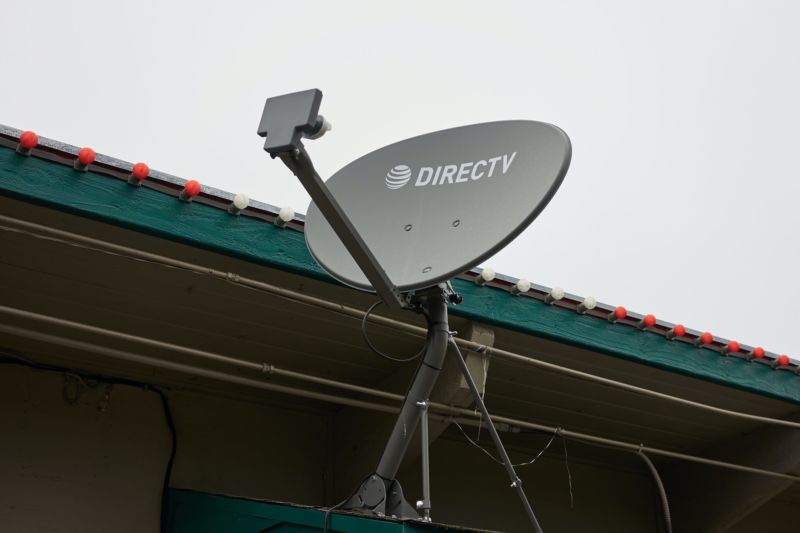 A Directv Satellite Dish Mounted To The Outside Of A Building.