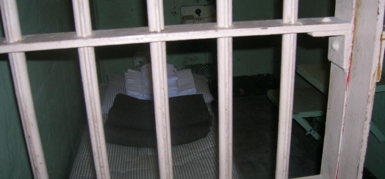 Stock photo of empty jail cell.