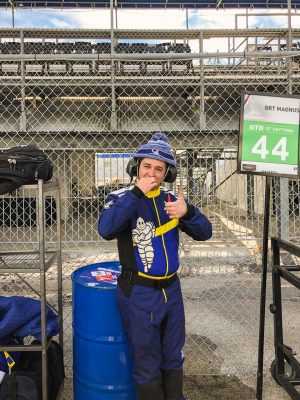 A mechanic in fireproof overalls brushes his teeth and gives the camera the thumbs up.