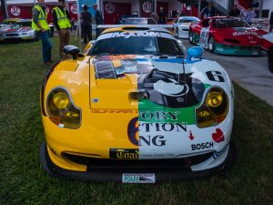 A yellow and white 1990s porsche race car.