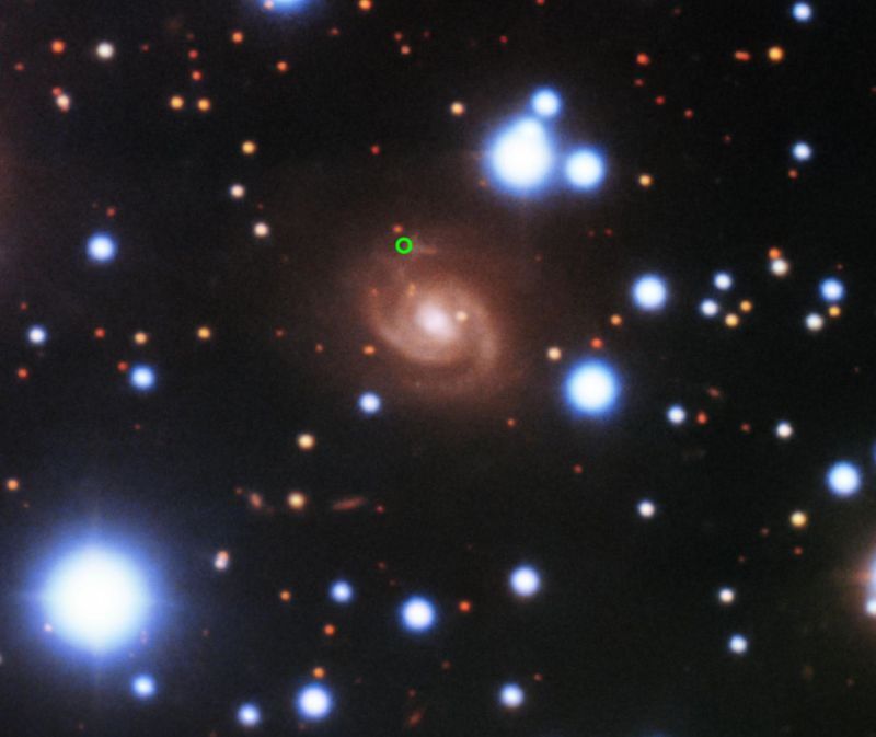 Image of a galaxy with a small green circle.