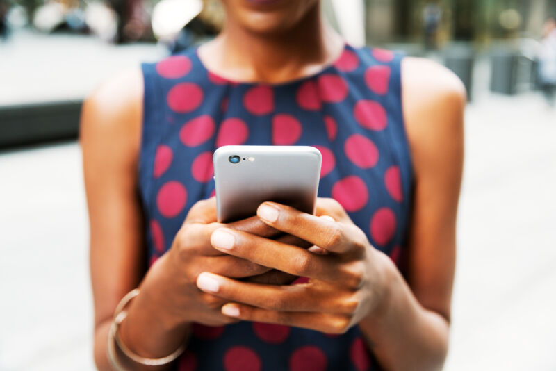 Woman holds phone