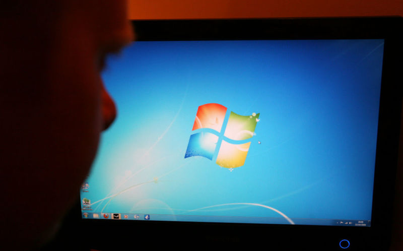 A man looks at the home screen for the "new" Windows 7 platform when it was  launched in October 2009. Microsoft has ended support, but the OS lives on.