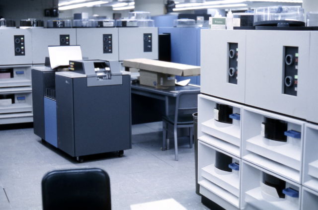 A number of IBM 2314 disk drives (white) and an IBM 2540 Card Reader / Punch, photographed in 1968.