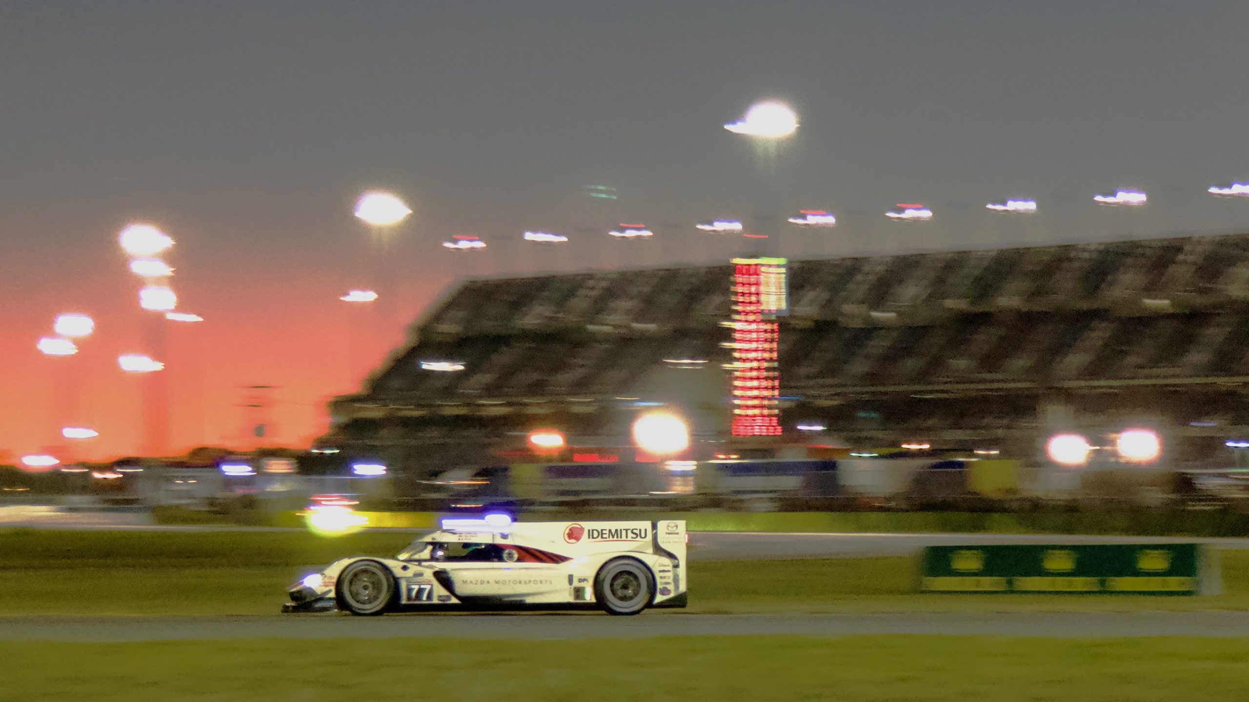 A white racing car at sunset