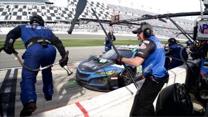 A blue race car gets a pit stop