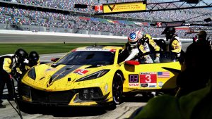 A yellow race car makes a pit stop.
