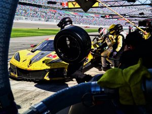 A yellow race car makes a pit stop.