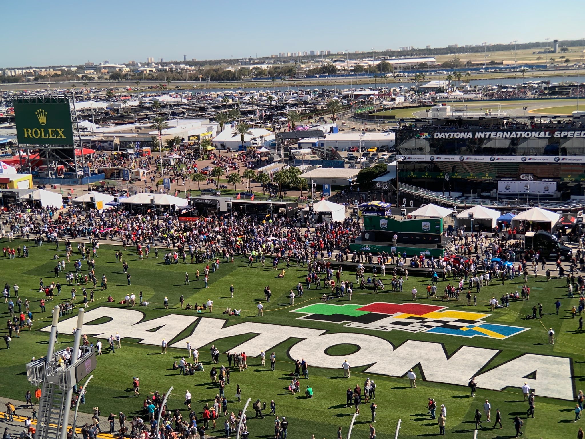 Crowds of people on the grass and pit lane at Daytona International Speedway