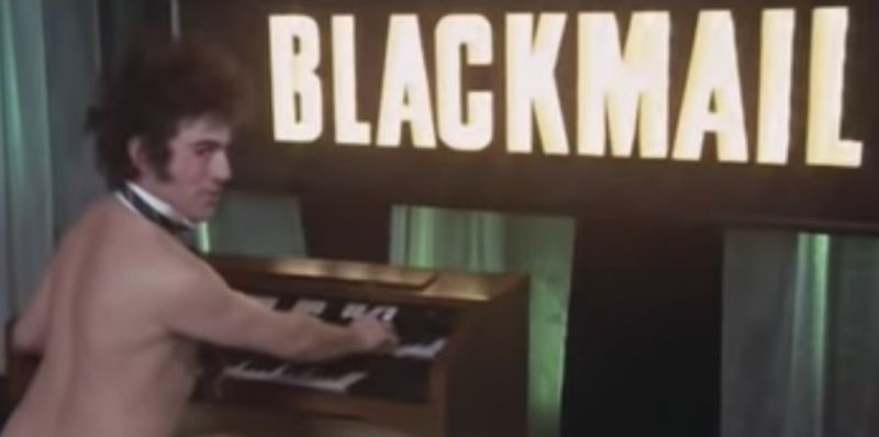 Terry Jones playing the organ <i>au naturel</i> in Monty Python's "Blackmail" sketch.