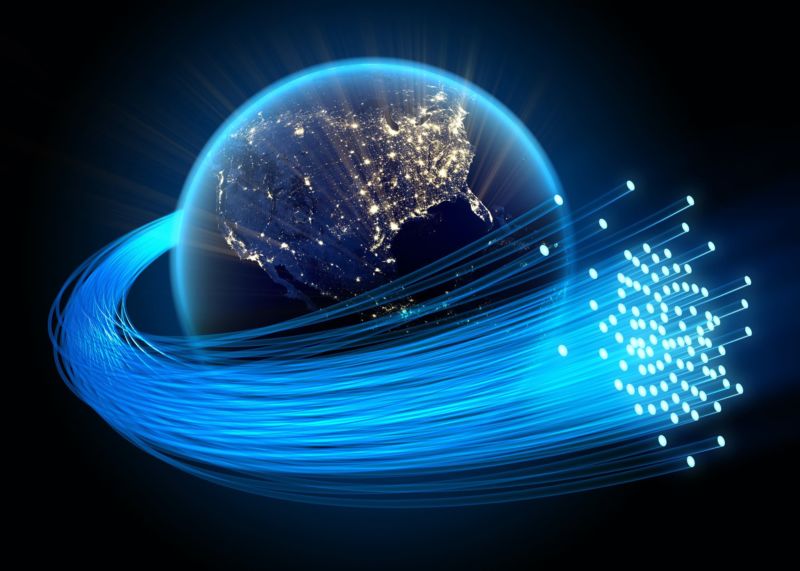 Illustration of the United States, with fiber-optic cables circling around the Earth.