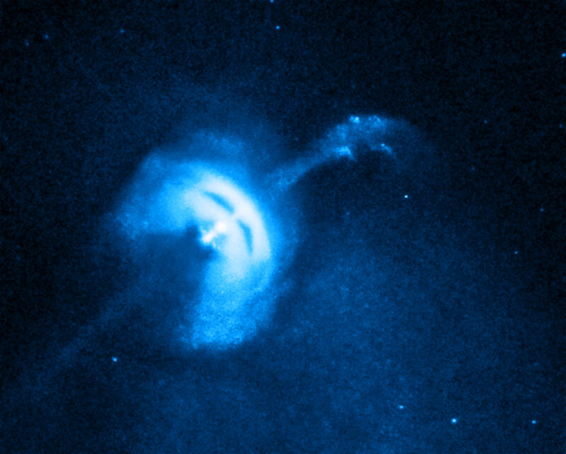 Image of diffuse blue rings surrounding a long, thin object.