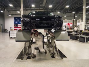A black NSX on ramps being aligned
