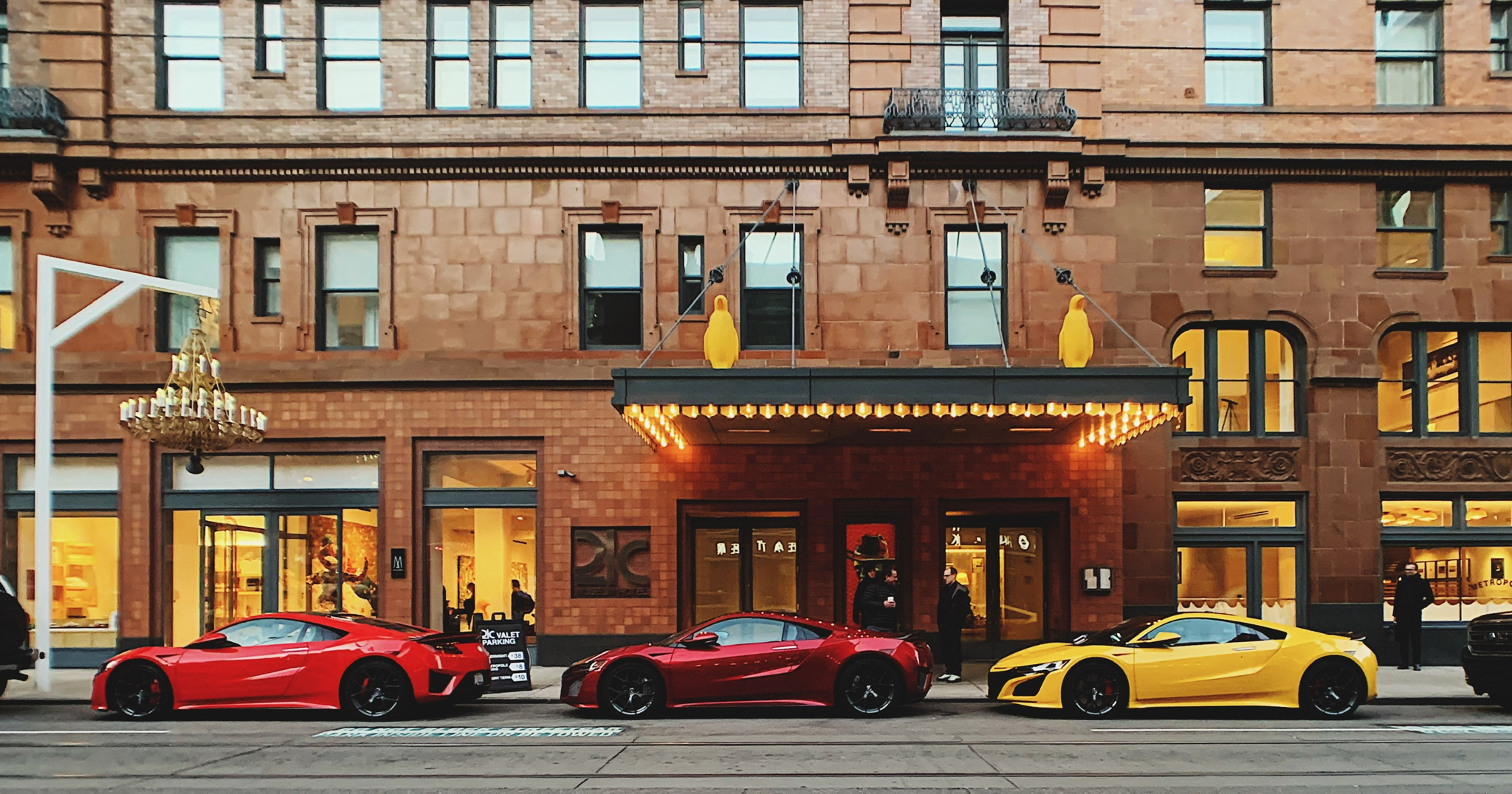 Two red and one yellow NSX parked in a row