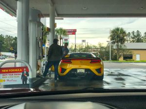 A yellow NSX refueling