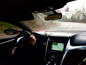 The view out the windshield of an NSX on a twisty road.