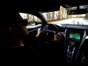 A man drives an NSX with snow on the ground