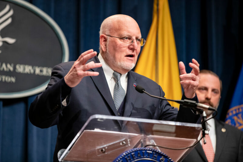 Image of a man gesturing behind a lectern.