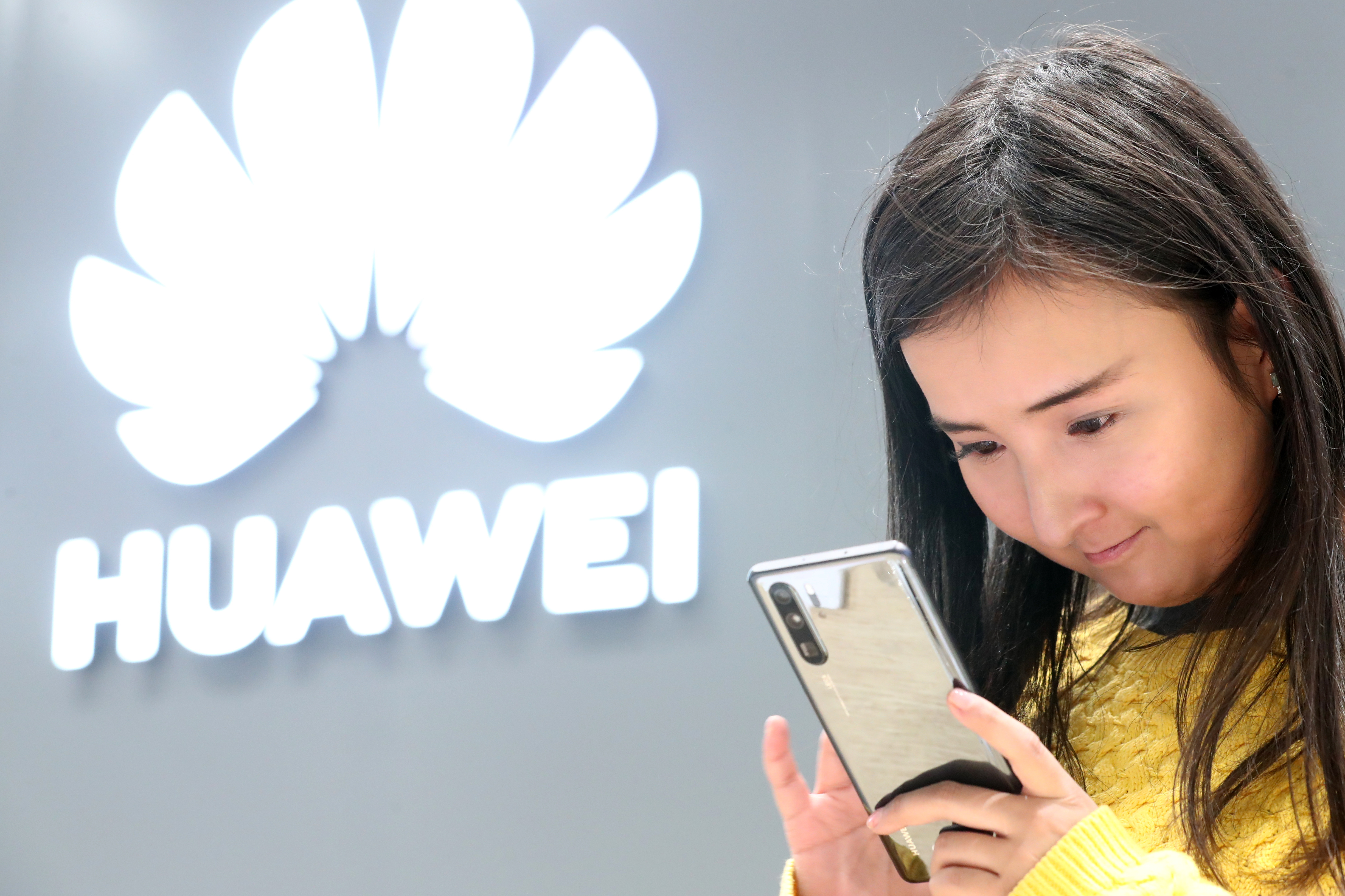 A customer looks at a Huawei smartphone in a Huawei store in Moscow.