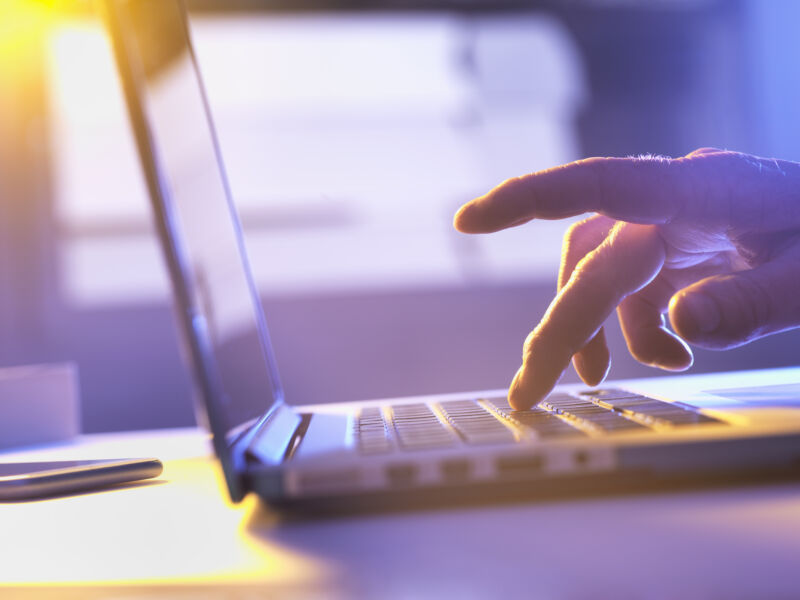 Man working online at a laptop computer