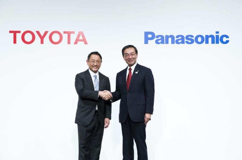 Two Japanese executives shake hands