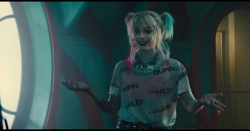 Margot Robbie, seen here sporting a shirt that will help you remember her character's name through the course of the film. Oh, and she's also smiling while explaining how she and her cohorts may die within the next few minutes. It's on par for the giddy insanity that is <em>Birds of Prey</em>.