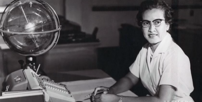 Katherine Johnson sits at her desk with a globe, or "Celestial Training Device." 