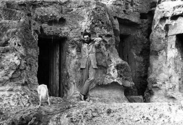 Flinders Petrie outside the tomb that served as his home on          the Giza Plateau. Sadly, this black-and-white image doesn't          allow us to see whether he's dressed in his trademark pink.