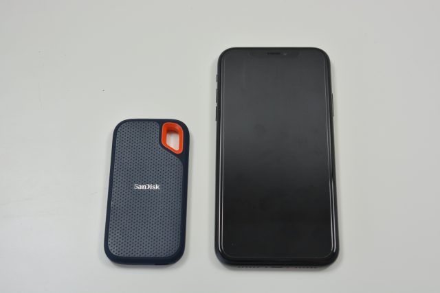 The SanDisk Extreme portable SSD alongside an iPhone XR.