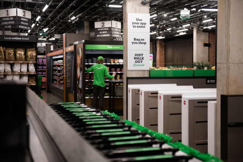 A lone employee works in a grocery store.