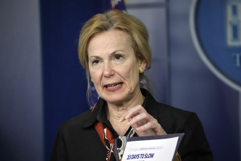 Image of a woman speaking at a press conference.