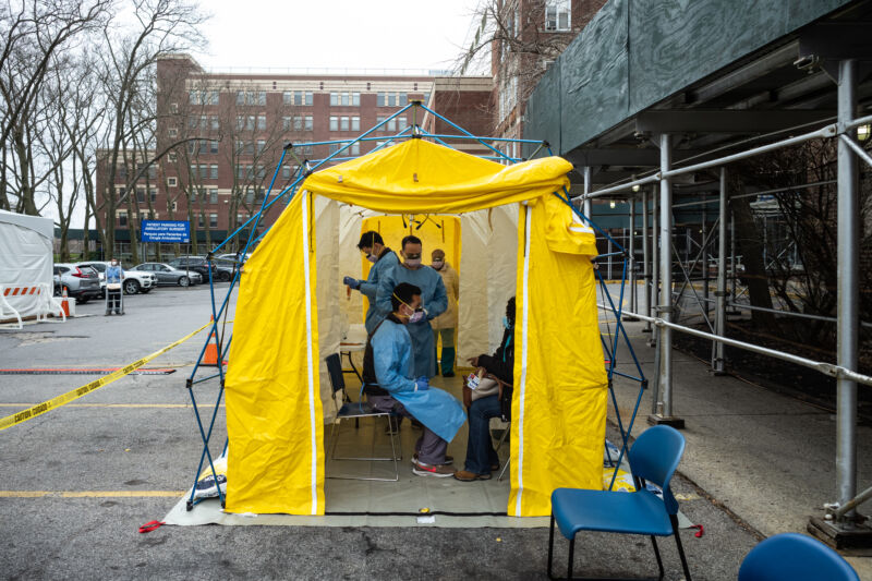 NEW YORK, NY - MARCH 20: Doctors test hospital staff with flu-like symptoms for COVID-19 at St. Barnabas hospital on March 20, 2020, in New York City. St. Barnabas hospital in the Bronx set up tents to triage possible COVID-19 patients outside before they enter the main Emergency department area. 