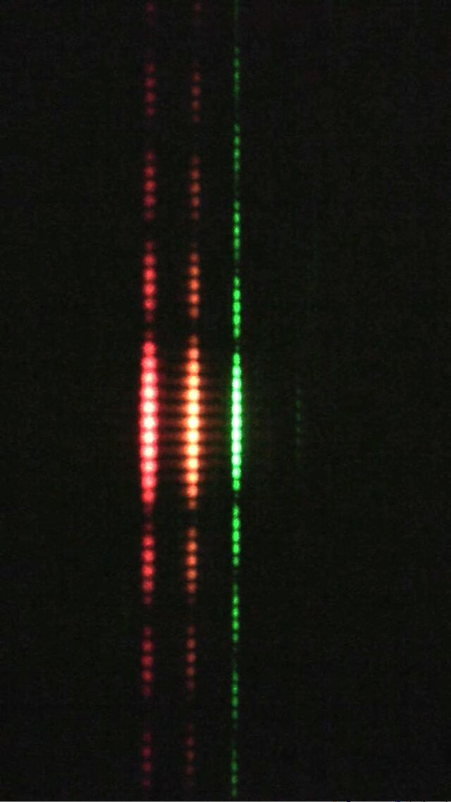 The stripes from sending red, orange, and green lasers through the same pair of slits. Notice how the green dots are closer together. 