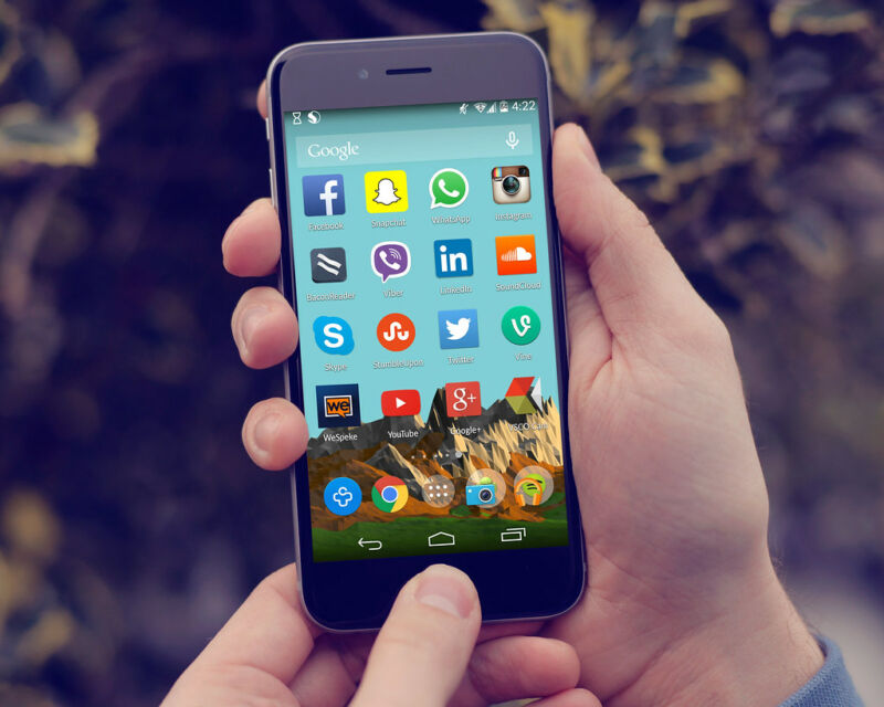 Closeup photograph of hands holding an Android phone.