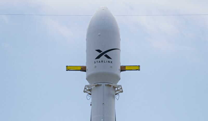 The top of a rocket has a SpaceX logo.