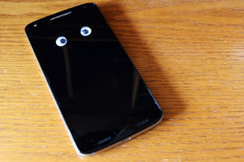 Photograph of a smartphone with googly eyes attached to it.