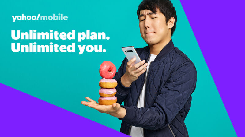 An ad for Yahoo Mobile showing a man taking a picture with a smartphone, with text that says 