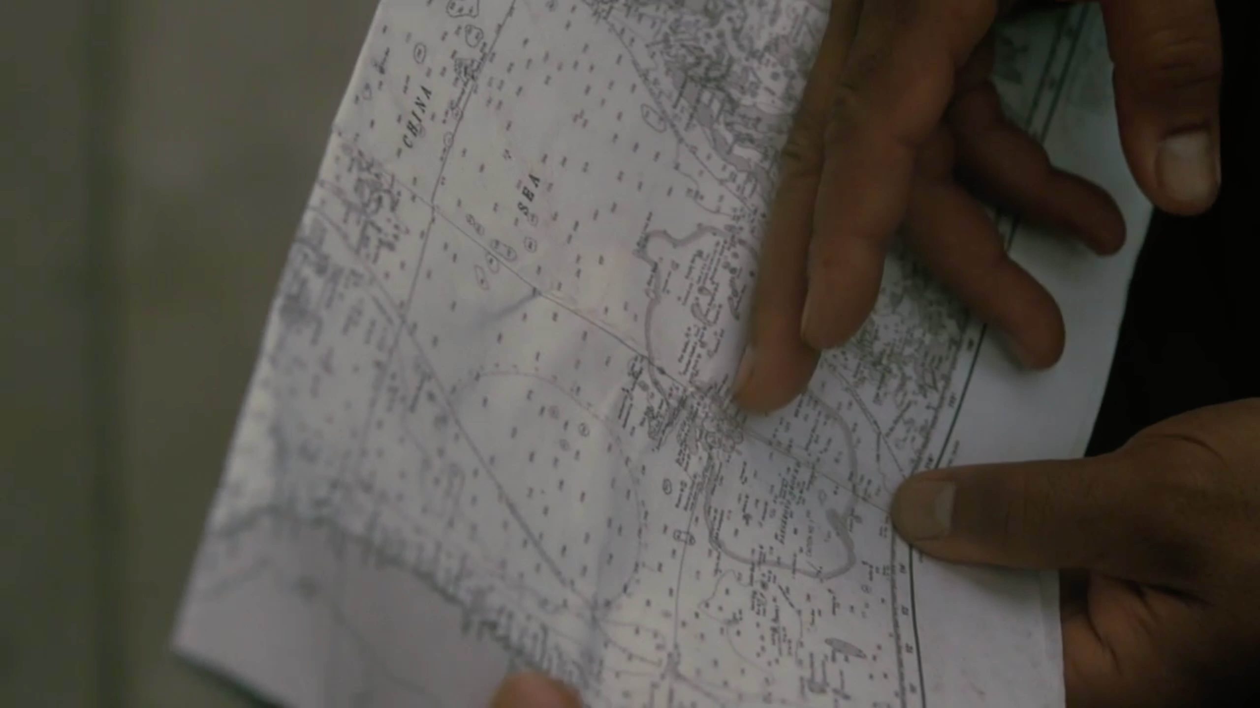 Screengrab of a man holding map.