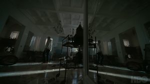 Image of a man in a trashed room.