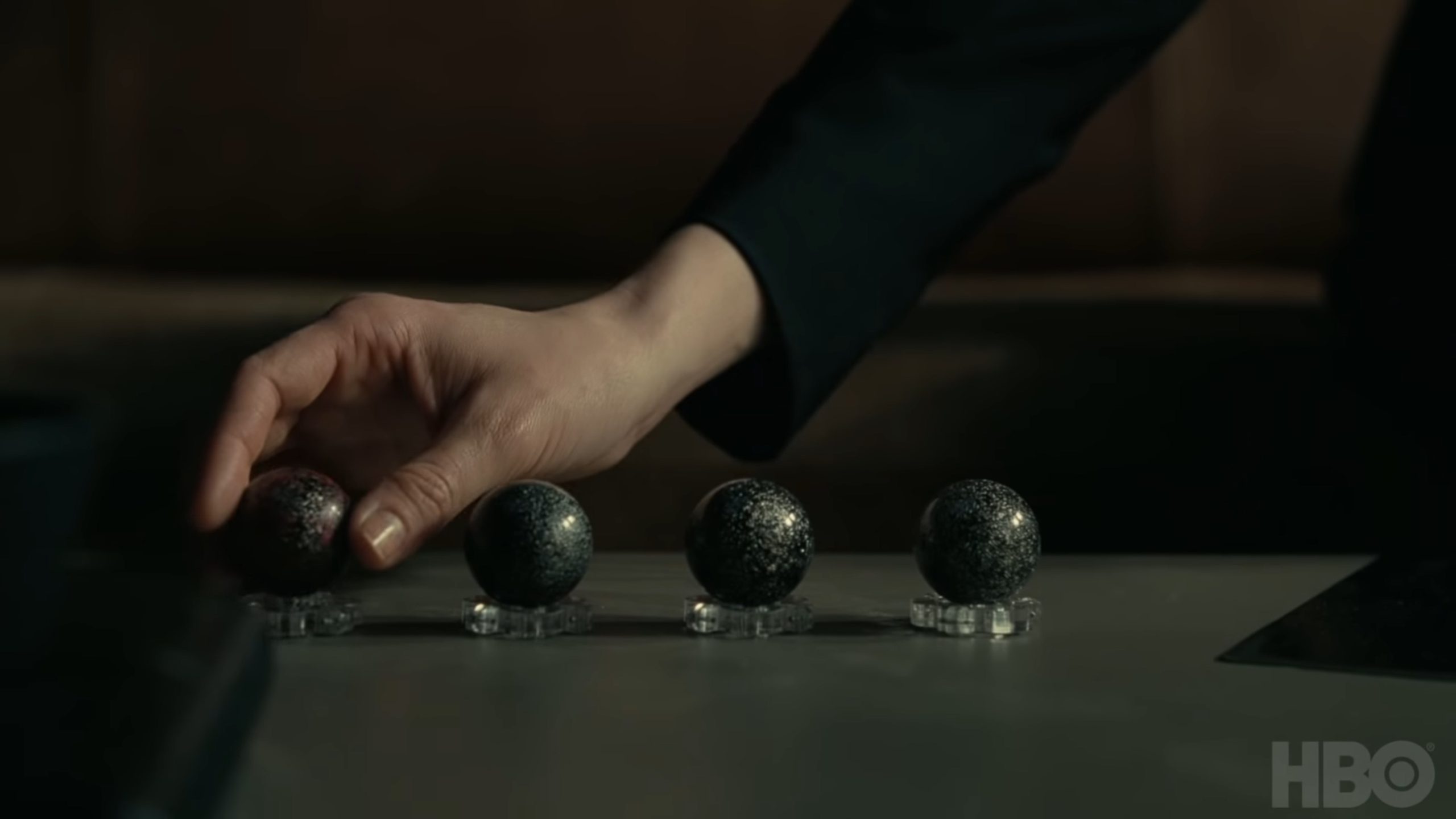 Image of a hand holding one of four host control units.