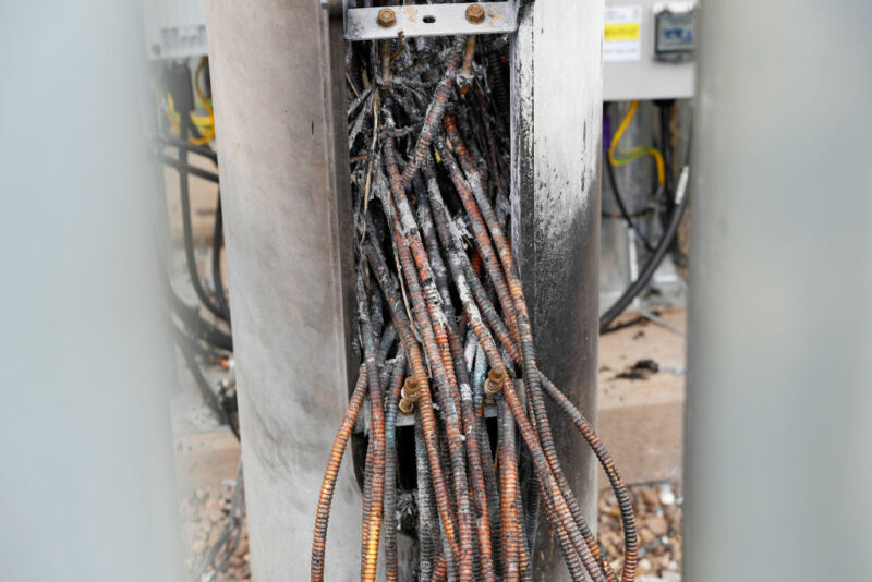 Fire-damaged cables protrude from the base of a telecom tower, reported in local media as being a 5G network mast on the EE network, operated by BT Group Plc, in Birmingham, U.K., on Monday, April 6, 2020. 