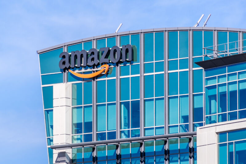 Multistory glass building with Amazon logo.