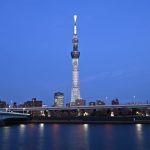 Image of a city skyline with a very tall tower at center.