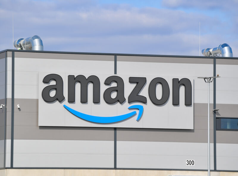 The Amazon logo on the side of a multi-story window.