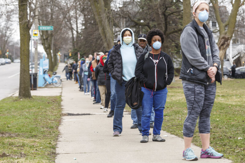 Milwaukee voters wait in line at Riverside High School on April 7, 2020.