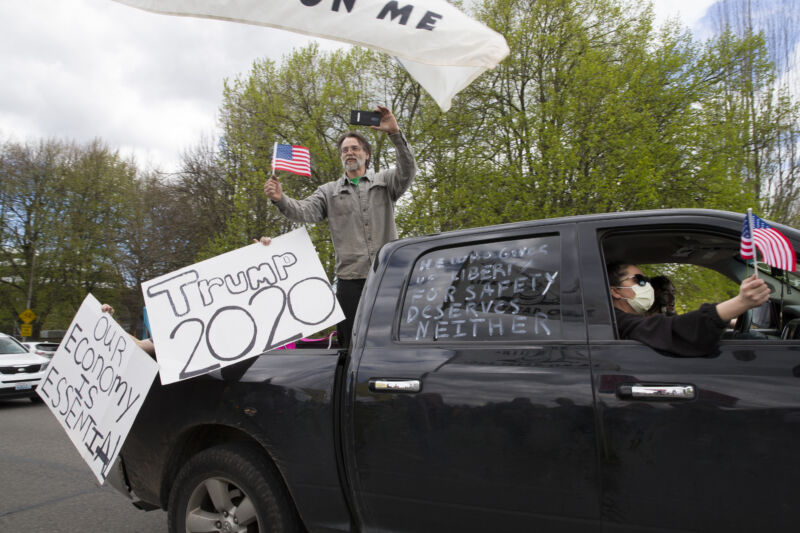 Protestors demonstrate against Washington state's stay-at-home order at the Capitol building in Olympia on April 19, 2020.